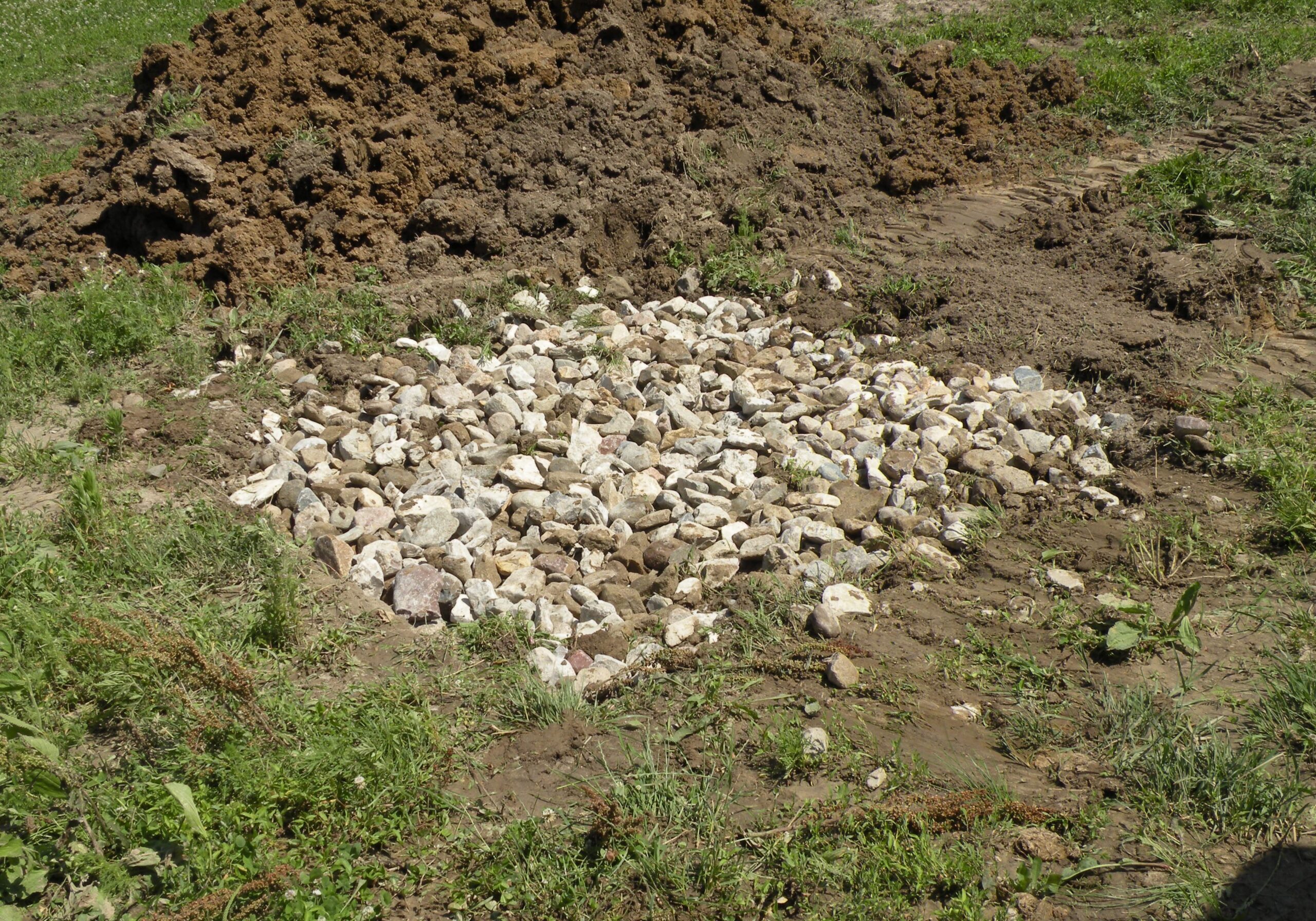 Level the river stone across the top of the pit.